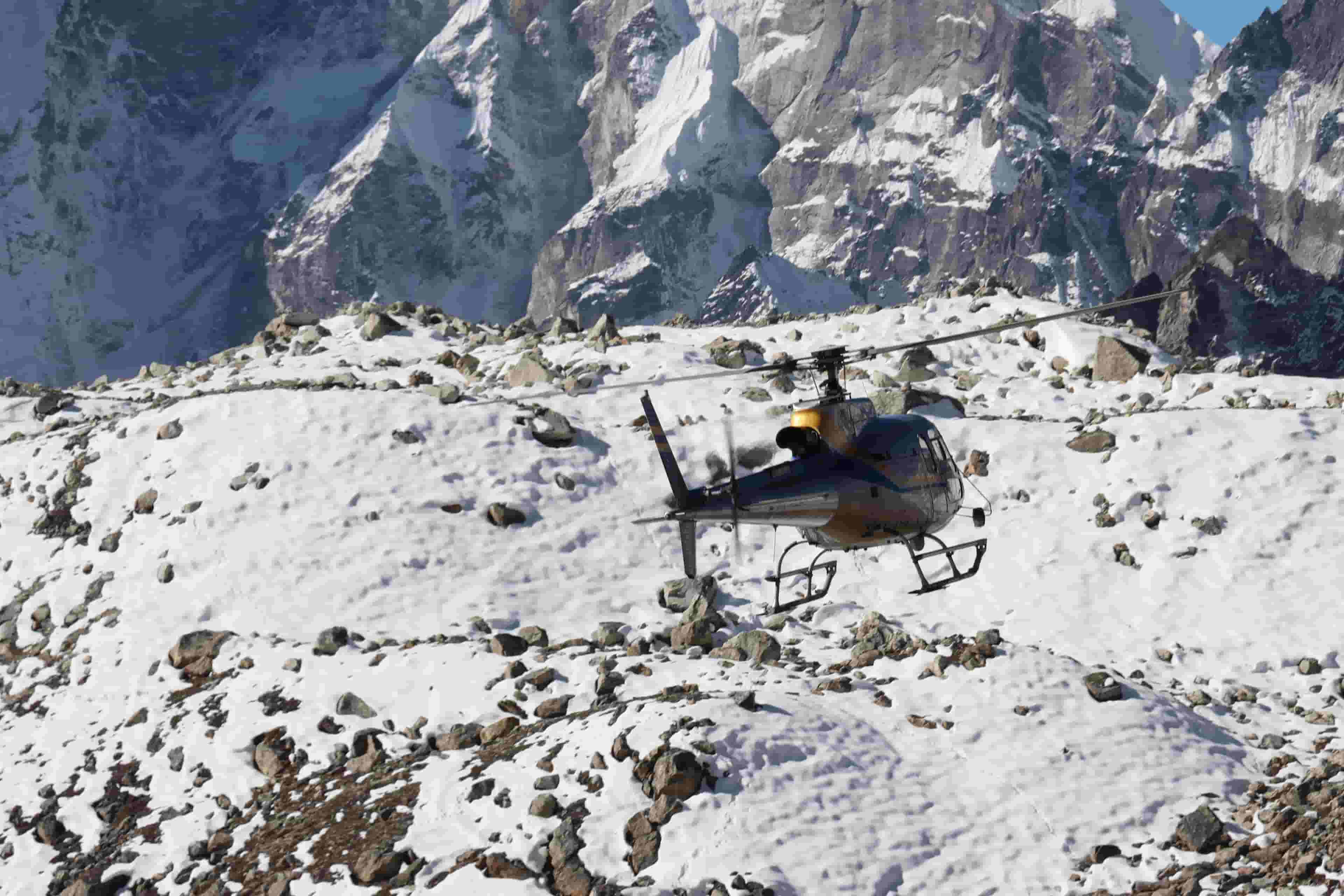 Helicopter hovering over the Khumbu region near Kala Patthar summit