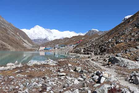 Morning light over Gokyo village with snowy peaks of Cho Oyu in the distance