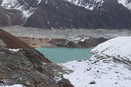 Stunning Gokyo Lake seen from Renjo La Pass, surrounded by rugged mountains and glaciers