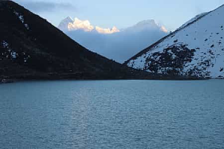 Serene evening over Gokyo Lake, turquoise waters beneath the towering Himalayas
