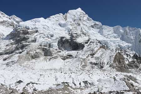 Everest and Nuptse rising side by side from Everest Base Camp on a clear blue-sky day