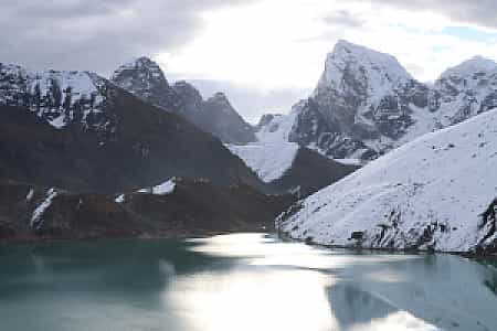 Himalayan landscape with Cholatse mountain and shimmering Gokyo Lake framed together