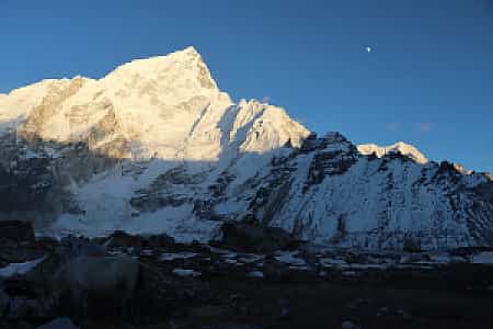 Nuptse glowing in twilight as the moon rises over Gorakshep, Nepal