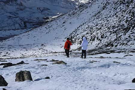 Snow-laden path from Kalapatthar with trekkers making their descent in the Khumbu region
