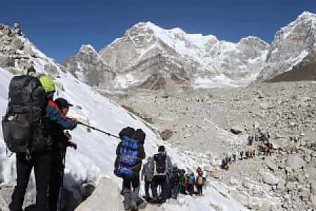 Crowded section of the EBC trail near Gorakshep, with trekkers lined up against the rocky landscape
