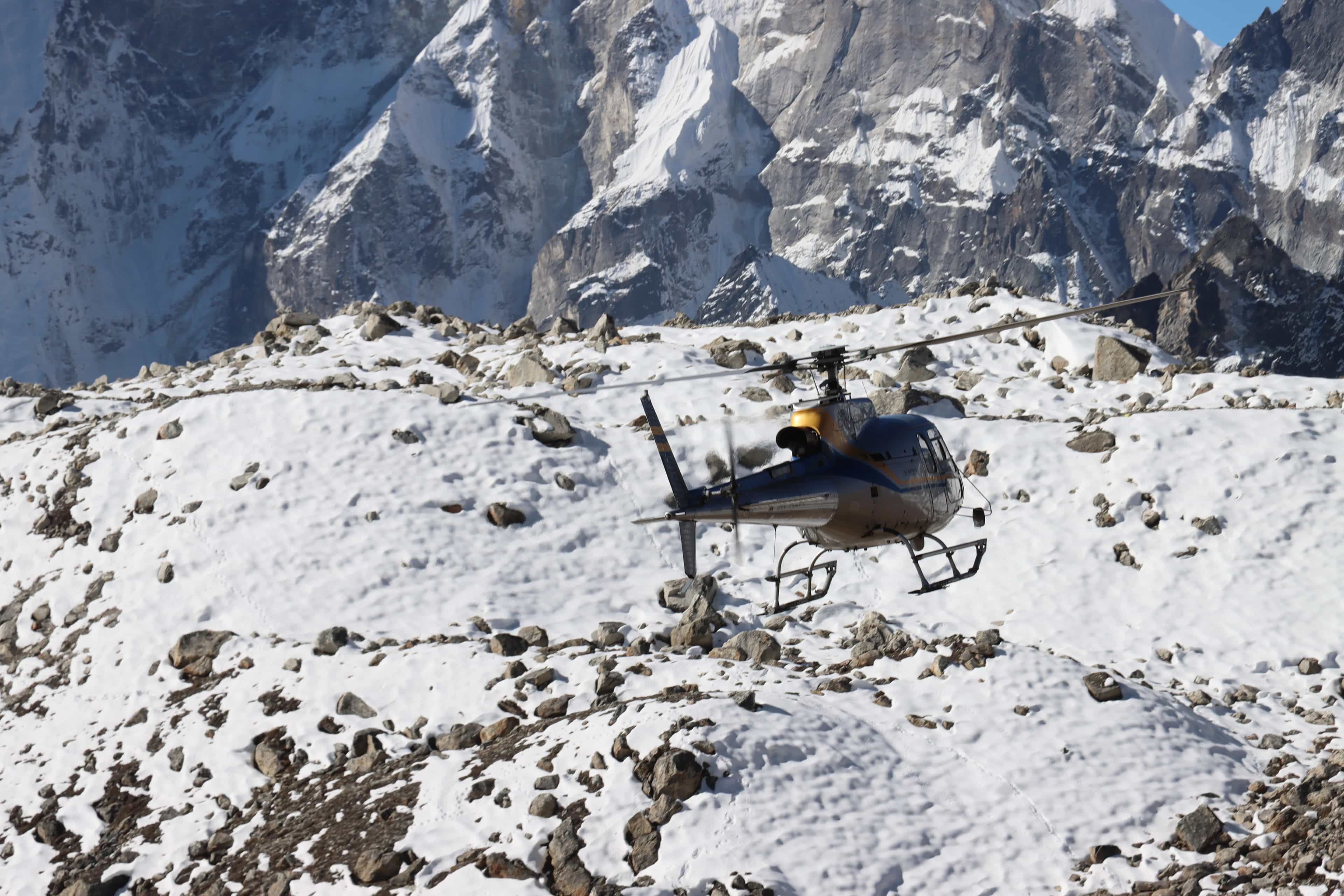 Helicopter hovering over the Khumbu region near Kala Patthar summit