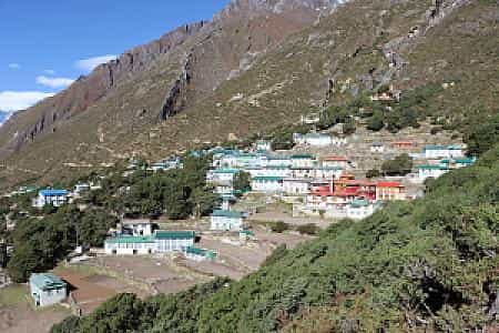 Clear view of Pangboche surrounded by green hills under bright sunshine
