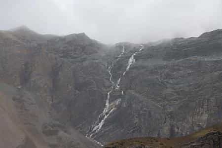 View from Thorong Phedi with towering cliffs and rugged Himalayan landscape on the Annapurna Region