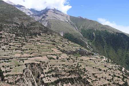 Pisang Peak partly hidden in clouds with Ghyaru village below, seen from the Annapurna Circuit trail